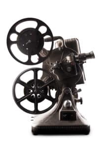 Vintage film projector on white background.